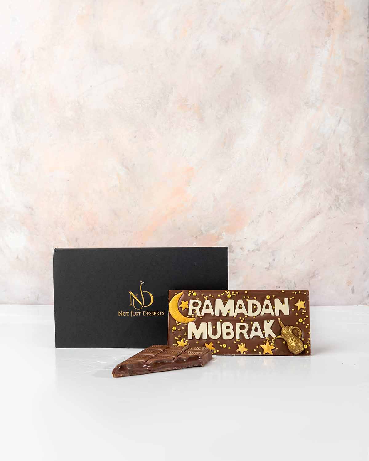 Ramadan Mubarak Chocolate Bar by NJDChocolate & ConfectioneryYour Gift Contains:• Ramadan Theme bar• Chocolate Weight: 140grams• Chocolate Size: 14.5x6.5cmx1cm• Box Size: 19x11x2cmHandling and Storage • Keep away from direct heat and sunlight• Best stored
