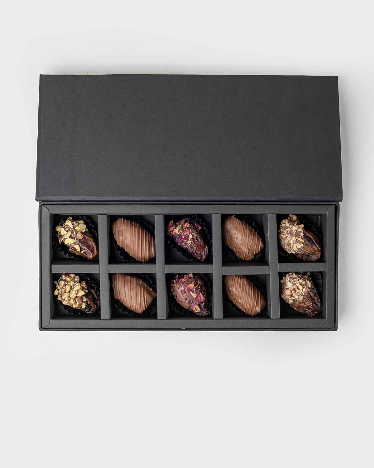 10 Assorted Dates Pack by NJDChocolate & ConfectioneryYour Gift Contains:• 10 x Belgian milk chocolate coated dates• Flavors: Roasted Pistachio, Milk chocolate Rose, Roasted Almonds• Box Size: 28x12x4cmHandling and Storage • Keep away from direct heat and