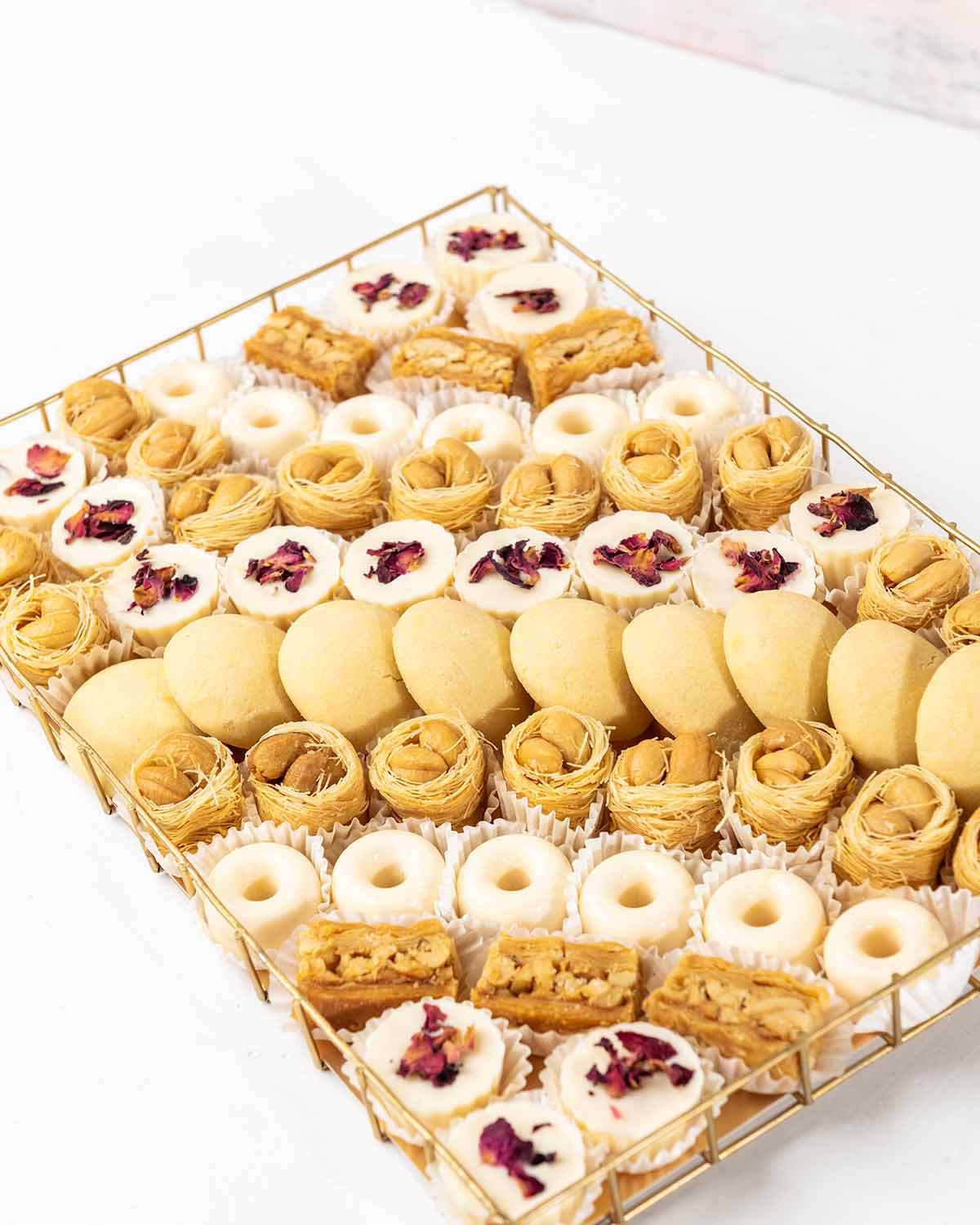 Cookies, Baklawa and Chocolate Hamper by NJDChocolate & ConfectioneryYour Gift Contains:• 10 x Freshly baked Butter cookies• 21 x Bul Bul Baklawa• 6 x Cashew Assieh • 27 x Assorted White Chocolates • Flavor: Pistachio, Hazelnut, Speculoos, Peanut Butter a