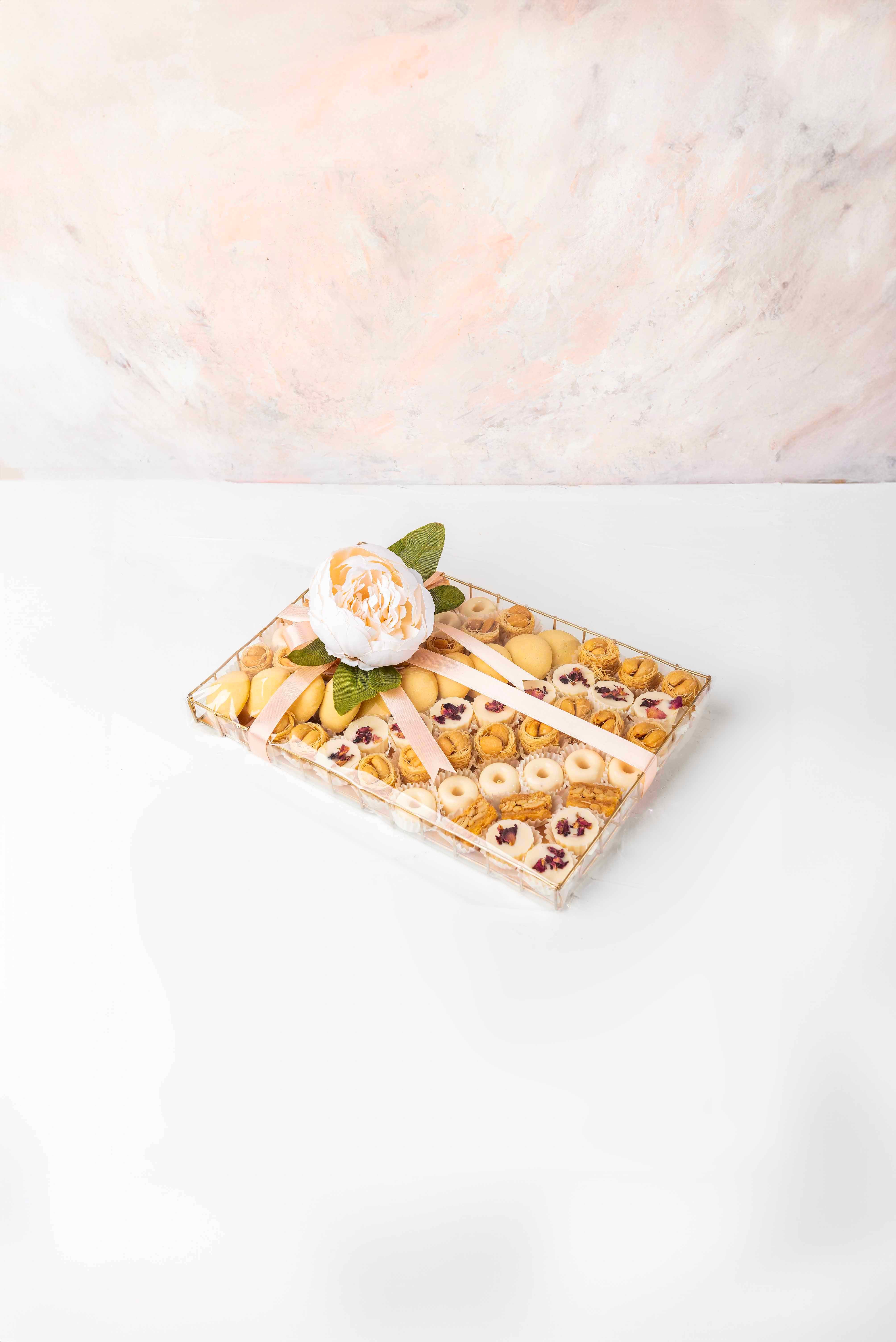 Cookies, Baklawa and Chocolate Hamper by NJDChocolate & ConfectioneryYour Gift Contains:• 10 x Freshly baked Butter cookies• 21 x Bul Bul Baklawa• 6 x Cashew Assieh • 27 x Assorted White Chocolates • Flavor: Pistachio, Hazelnut, Speculoos, Peanut Butter a