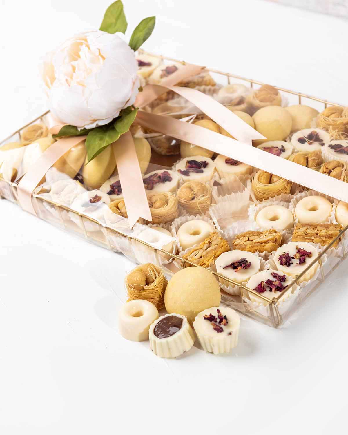 Cookies, Baklawa and Chocolate Hamper by NJDChocolate & ConfectioneryYour Gift Contains:• 10 x Freshly baked Butter cookies• 21 x Bul Bul Baklawa• 6 x Cashew Assieh • 27 x Assorted White Chocolates • Flavor: Pistachio, Hazelnut, Speculoos, Peanut Butter a