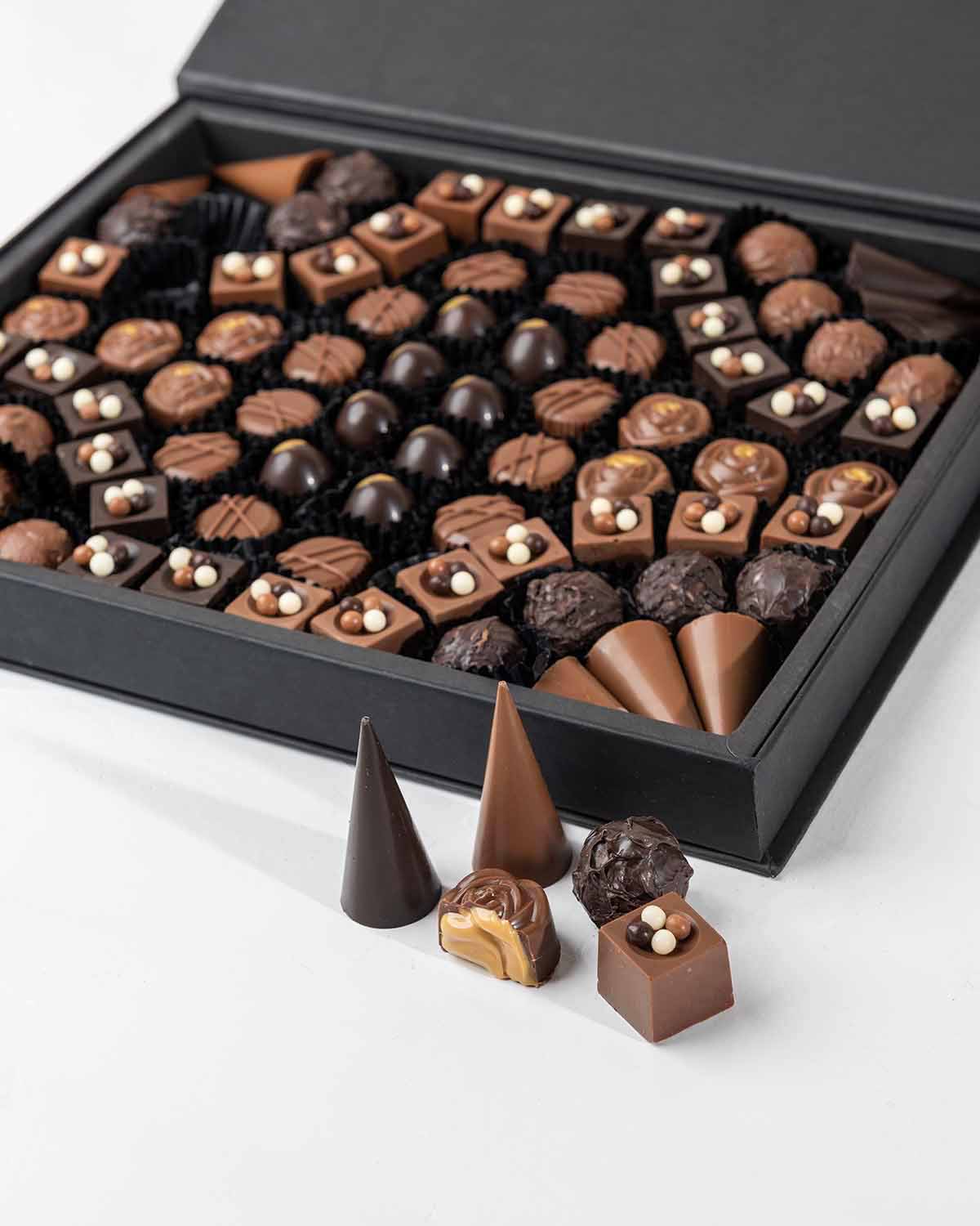 84 Assorted Chocolates by NJDChocolate & ConfectioneryYour Gift Contains:• 84 x Assorted Milk and Dark Chocolates • Flavors: Pistachio, Hazelnut, Speculoos, Peanut Butter, Roche, Cappuccino Cream, Dark Chocolate Cream, Raffaello, Salted Caramel• Chocolate