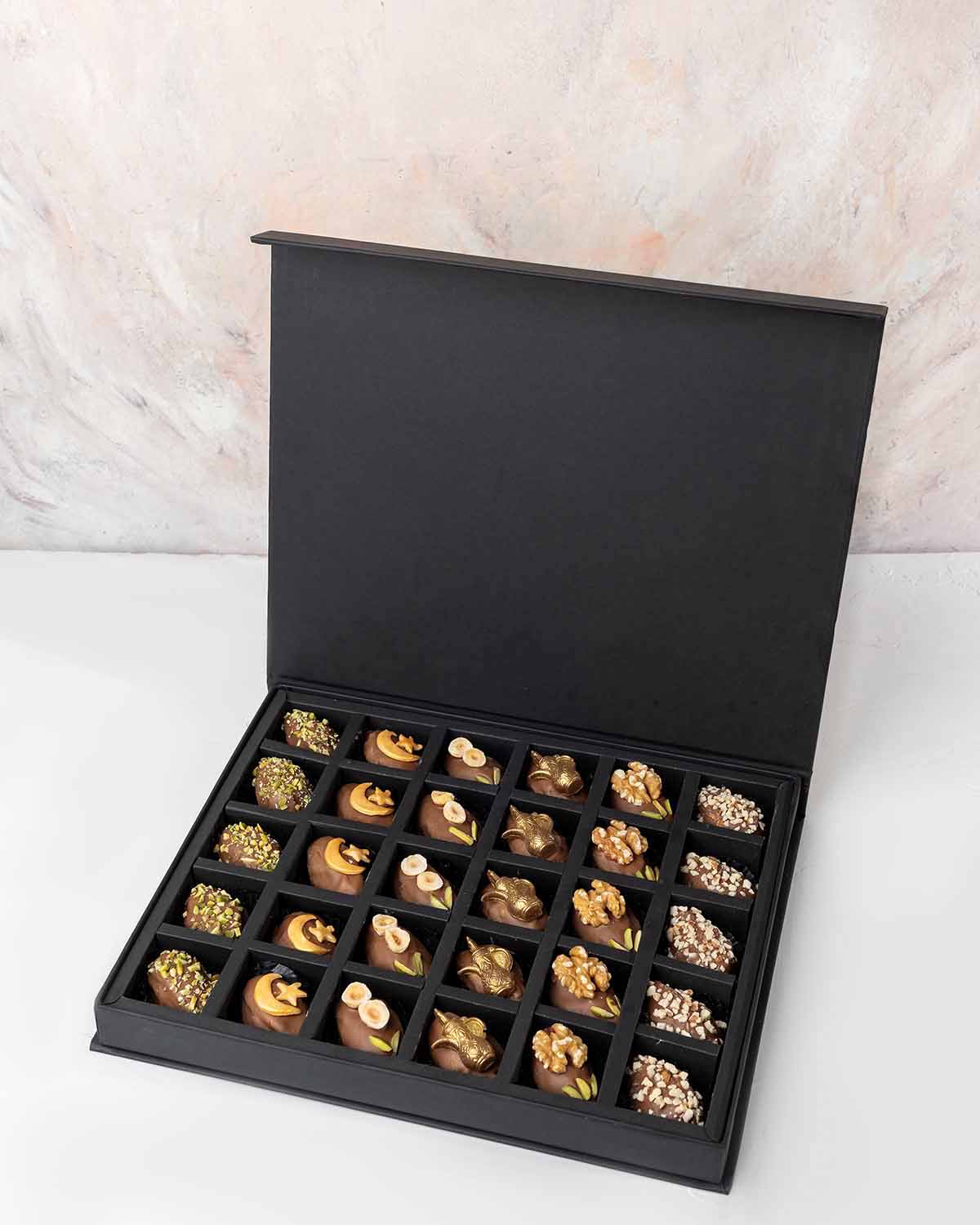 30 Designer Dates by NJDChocolate & ConfectioneryYour Gift Contains:• Belgian Milk chocolate and Pistachio covered dates • 5 x Belgian Milk chocolate covered dates with crescent • 5 x Belgian Milk chocolate covered dates with Macadamia topping• 5 x Belgia