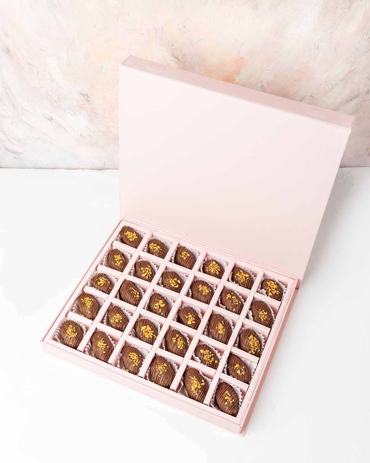 30 Chocolate Covered Dates by NJDChocolate & ConfectioneryYour Gift Contains:• 30 x Belgian Milk Chocolate covered Premium Majdoul dates • Box Size: 31x26x3.5cmHandling and Storage • Keep away from direct heat and sunlight• Best stored between 12-18 °C• S