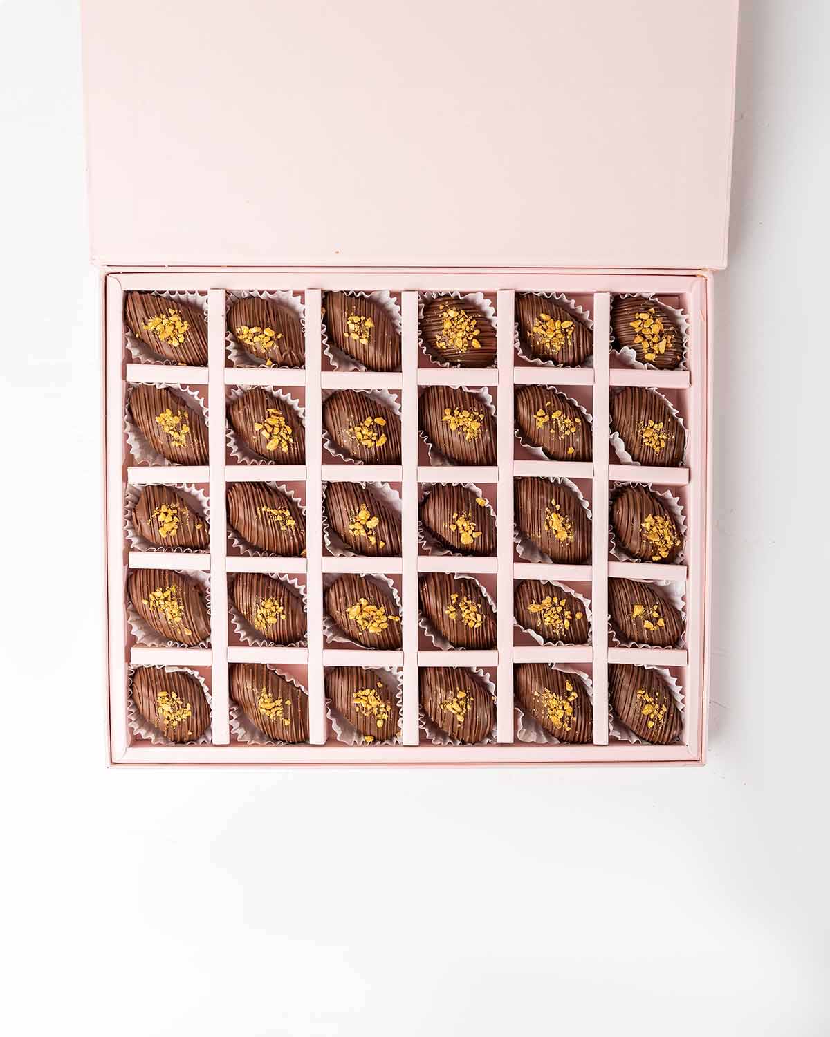 30 Chocolate Covered Dates by NJDChocolate & ConfectioneryYour Gift Contains:• 30 x Belgian Milk Chocolate covered Premium Majdoul dates • Box Size: 31x26x3.5cmHandling and Storage • Keep away from direct heat and sunlight• Best stored between 12-18 °C• S