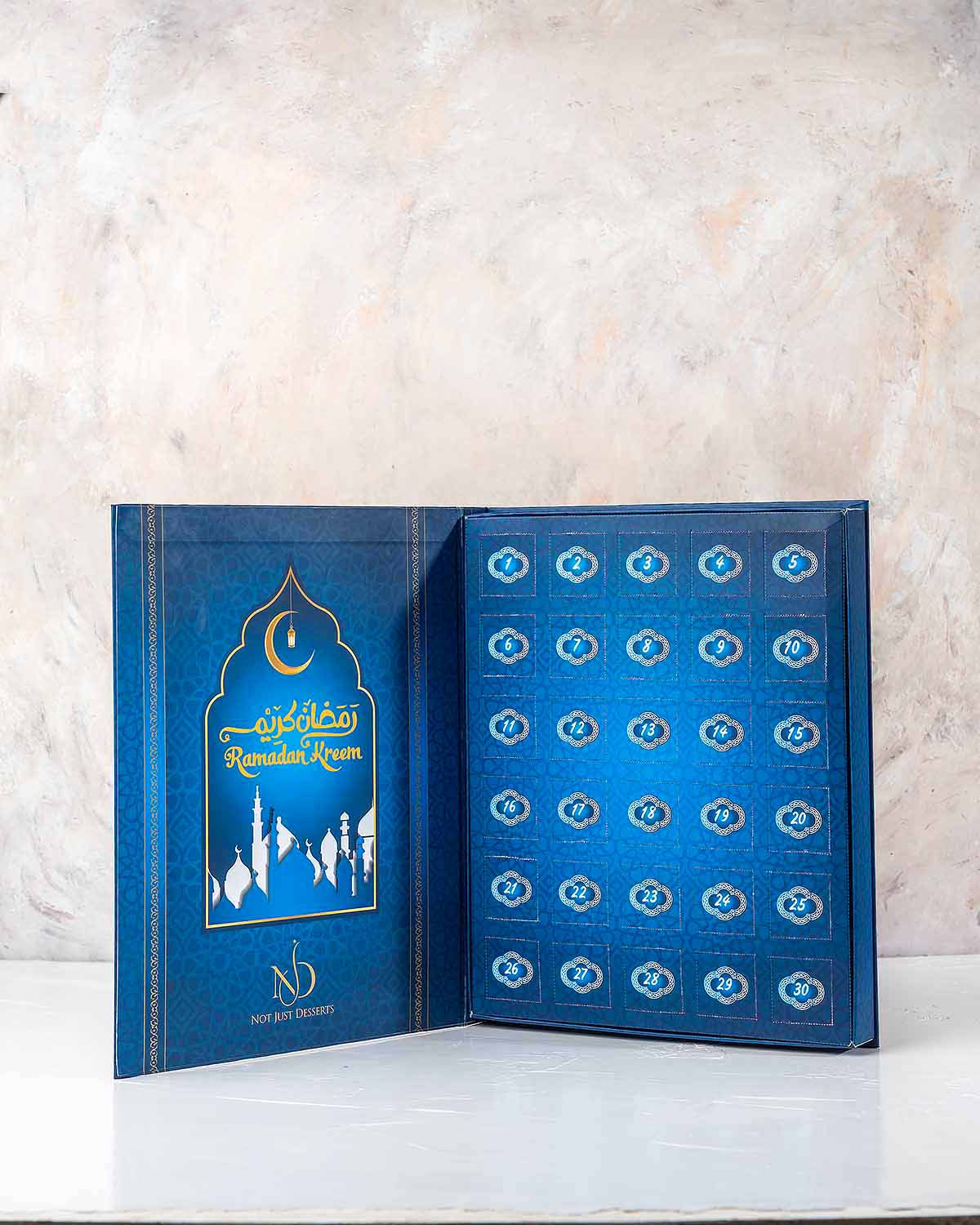 Ramadan Advent Calendar by NJDChocolate & ConfectioneryYour Gift Contains:• 15 x Chocolate covered dates with roasted nuts• 15 x Assorted Milk Chocolates• Chocolate Flavors: Pistachio, Hazelnut, Speculoos, Peanut Butter, Roche and Speculoos • Chocolate We