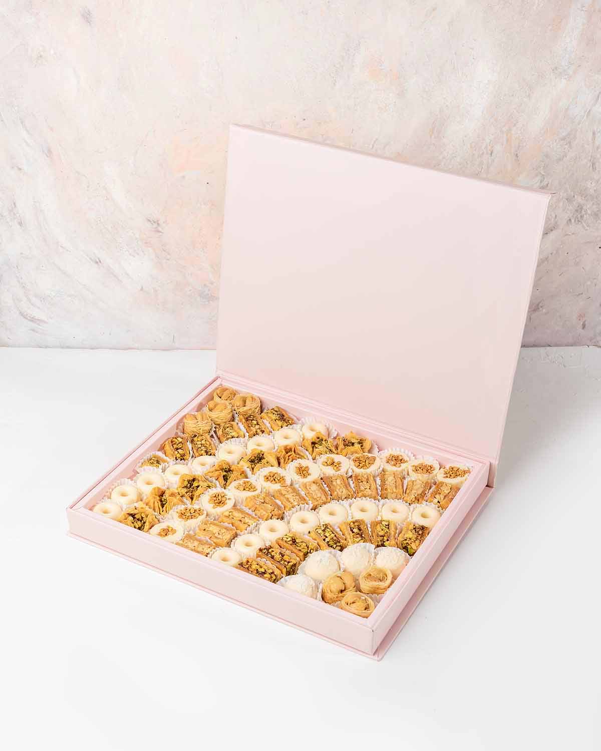 Baklawa and Chocolates Gift Box by NJDChocolate & ConfectioneryYour Gift Contains:• 7 x Bul Bul Cashew Baklawa• 4 x White chocolate assorted truffles • 12 x Assieh Pistachio• 11 x Assieh Cashew• 28 x Assorted White chocolates• 8 x Bookaj Pistachio• Flavor