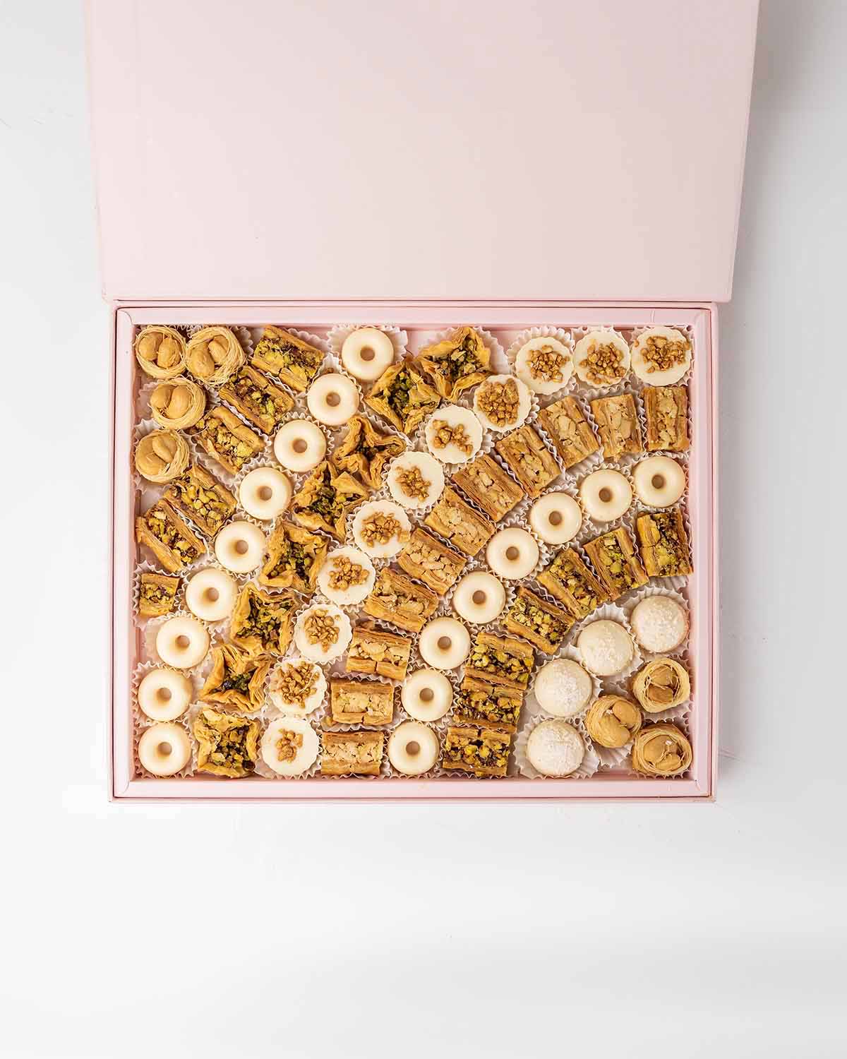 Baklawa and Chocolates Gift Box by NJDChocolate & ConfectioneryYour Gift Contains:• 7 x Bul Bul Cashew Baklawa• 4 x White chocolate assorted truffles • 12 x Assieh Pistachio• 11 x Assieh Cashew• 28 x Assorted White chocolates• 8 x Bookaj Pistachio• Flavor
