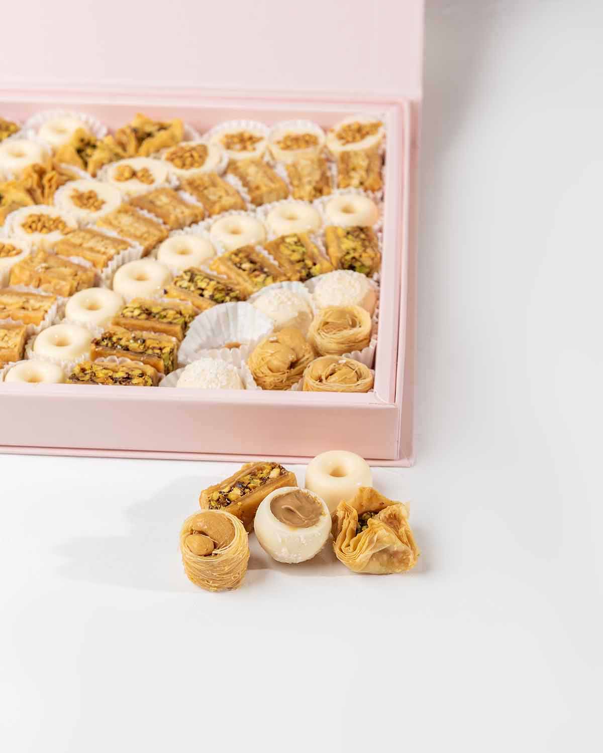 Baklawa and Chocolates Gift Box by NJDChocolate & ConfectioneryYour Gift Contains:• 7 x Bul Bul Cashew Baklawa• 4 x White chocolate assorted truffles • 12 x Assieh Pistachio• 11 x Assieh Cashew• 28 x Assorted White chocolates• 8 x Bookaj Pistachio• Flavor