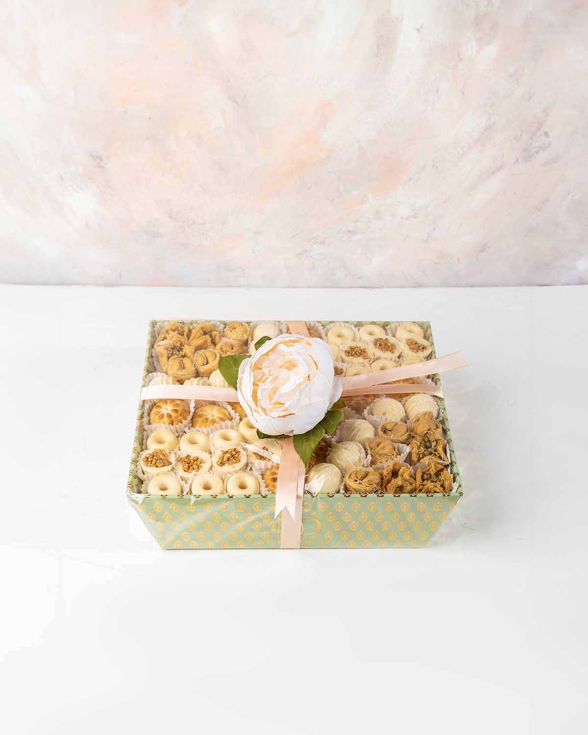 Truffles, Chocolates and Assorted Arabic Desserts by NJDChocolate & ConfectioneryYour Gift Contains:• 6 x Bookaj Pistachio• 8 x Bul Bul Cashew Baklawa• 11 x White Chocolate assorted Truffles • 11 x Mamoul with Dates• 25 x White assorted chocolates• Box Si