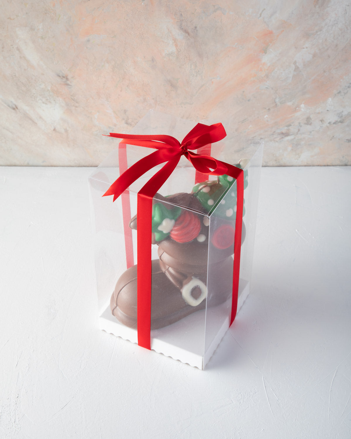 Edible Santa Boot by NJDChocolate & ConfectioneryYOUR GIFT CONTAINS Approx. 600 grams pure Belgian milk chocolate Santa Boot decorated with colored chocolate Chocolate Dimensions: LxBxH: 16x8x18cm Flavors: Pure Belgian Milk chocolate and Color chocolate B