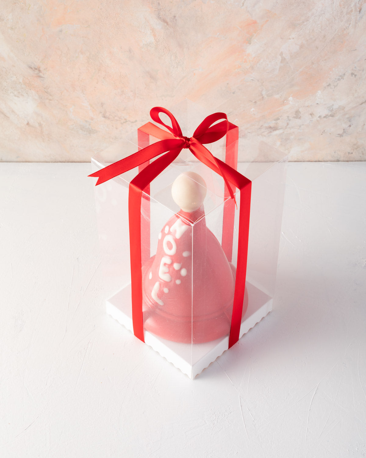 Edible Santa hat by NJDChocolate & ConfectioneryYOUR GIFT CONTAINS Christmas tree, inspired by the shape of a Christmas hat made with approx 500gms pure Belgian milk and colored chocolate making it a great Christmas gift Chocolate Dimensions: LxBxH: 13x13