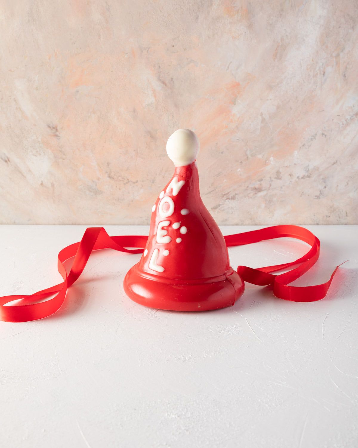 Edible Santa hat by NJDChocolate & ConfectioneryYOUR GIFT CONTAINS Christmas tree, inspired by the shape of a Christmas hat made with approx 500gms pure Belgian milk and colored chocolate making it a great Christmas gift Chocolate Dimensions: LxBxH: 13x13