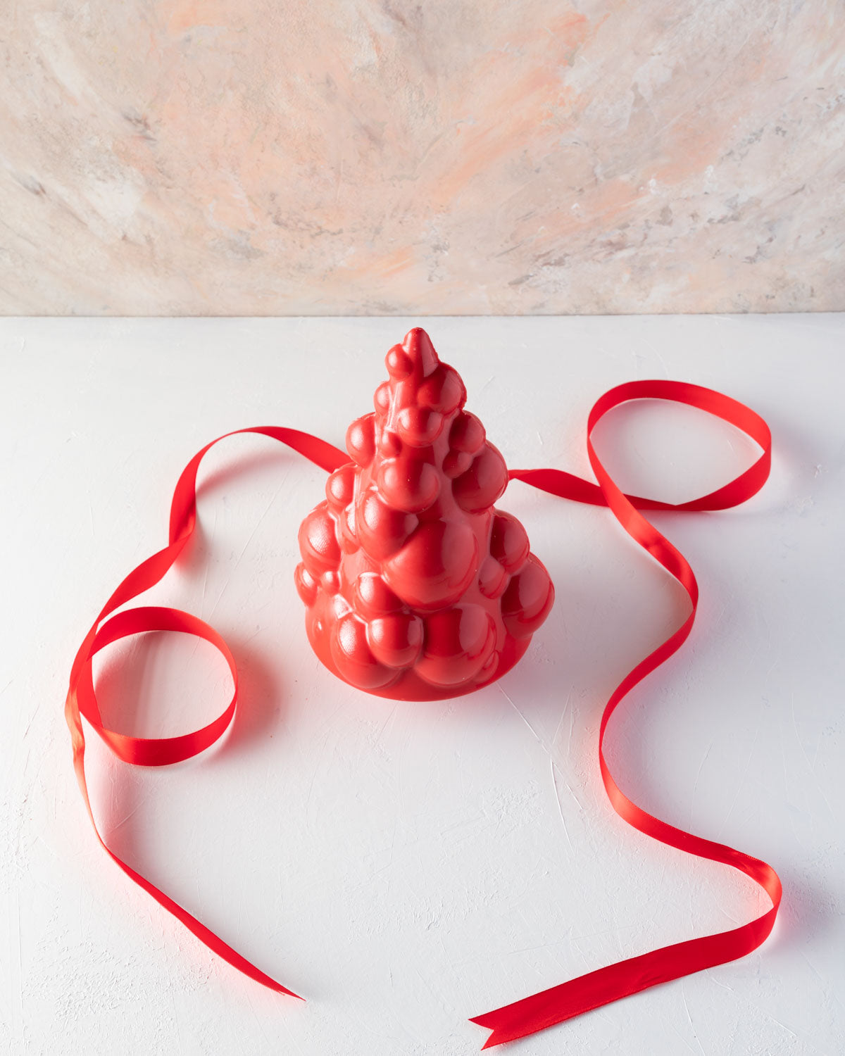 Edible Baoubly Xmas TreeChocolate & ConfectioneryYOUR GIFT CONTAINS Christmas tree inspired by baubles and pops design made with approx 600gms milk and colored chocolate Chocolate Dimensions: LxBxH: 13.5x13.5x20cm Flavors: Pure Belgian Milk chocolate and