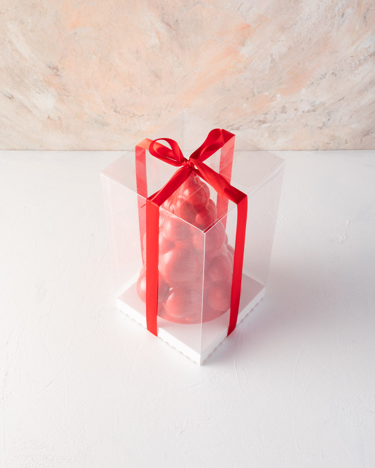 Edible Baoubly Xmas TreeChocolate & ConfectioneryYOUR GIFT CONTAINS Christmas tree inspired by baubles and pops design made with approx 600gms milk and colored chocolate Chocolate Dimensions: LxBxH: 13.5x13.5x20cm Flavors: Pure Belgian Milk chocolate and