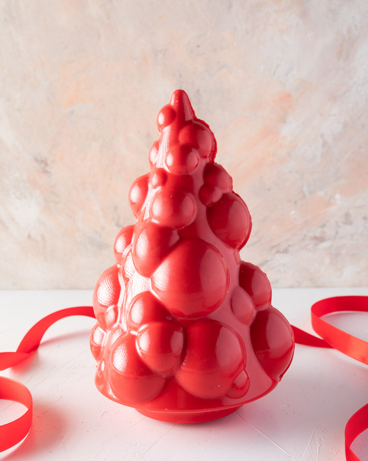 Edible Baoubly Xmas TreeChocolate & ConfectioneryYOUR GIFT CONTAINS Christmas tree inspired by baubles and pops design made with approx 600gms milk and colored chocolate Chocolate Dimensions: LxBxH: 13.5x13.5x20cm Flavors: Pure Belgian Milk chocolate and