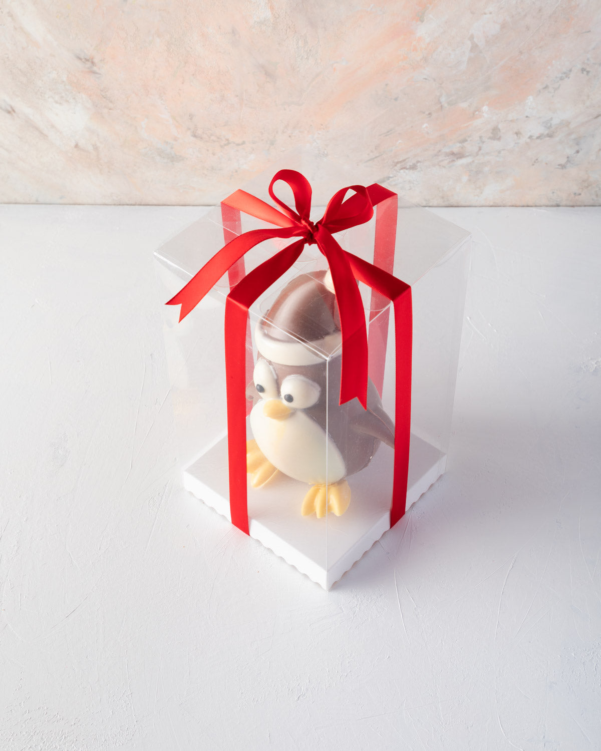 Edible Xmas PenguineChocolate & ConfectioneryYOUR GIFT CONTAINS Chocolate penguin, a cheerful Christmas character made with approx 400gms milk chocolate Chocolate Dimensions: LxBxH: 13x10.5x17cm Flavors: Pure Belgian Milk chocolate and Color chocolate Box