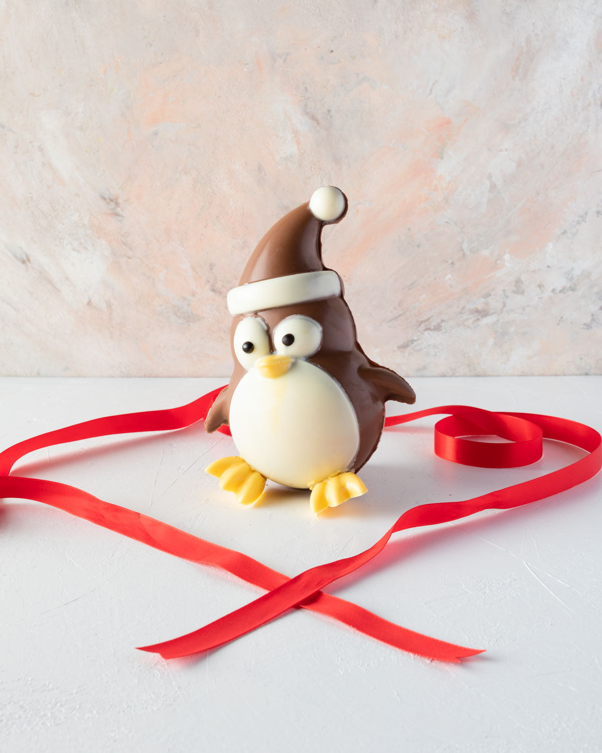 Edible Xmas PenguineChocolate & ConfectioneryYOUR GIFT CONTAINS Chocolate penguin, a cheerful Christmas character made with approx 400gms milk chocolate Chocolate Dimensions: LxBxH: 13x10.5x17cm Flavors: Pure Belgian Milk chocolate and Color chocolate Box