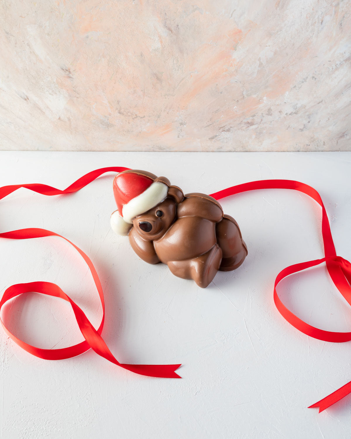 Chocolaty Comfort TeddyChocolate & ConfectioneryYOUR GIFT CONTAINS Edible Comfy teddy made with approx 500gms milk and colored chocolate. Chocolate Dimensions: LXBXH: 18.5x11x10.5cm Flavors: Pure Belgian Milk chocolate and Color chocolate Box dimensions: