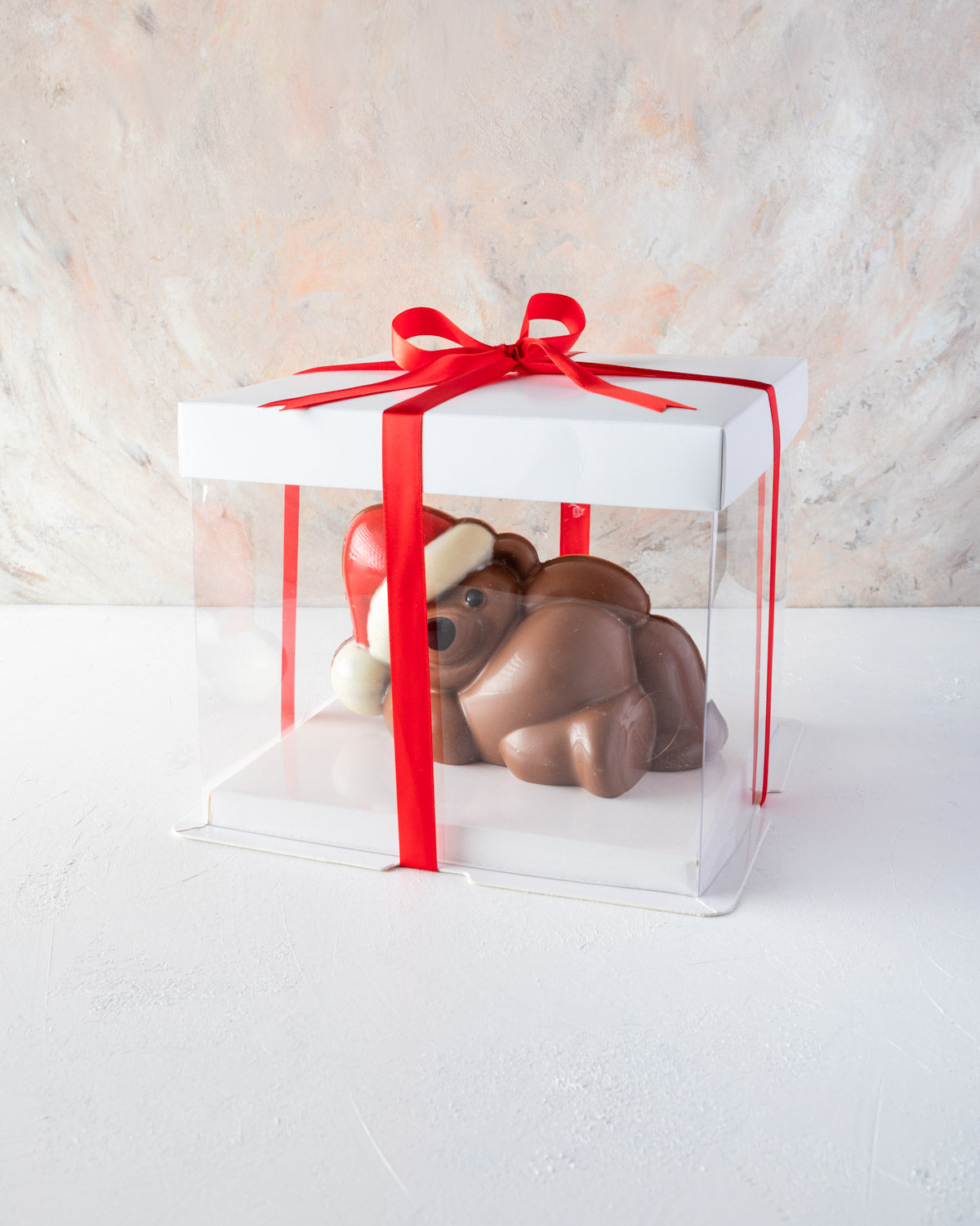 Chocolaty Comfort TeddyChocolate & ConfectioneryYOUR GIFT CONTAINS Edible Comfy teddy made with approx 500gms milk and colored chocolate. Chocolate Dimensions: LXBXH: 18.5x11x10.5cm Flavors: Pure Belgian Milk chocolate and Color chocolate Box dimensions: