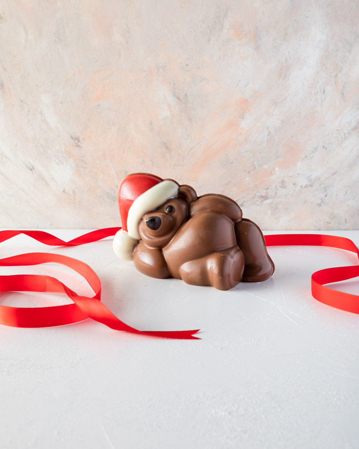 Chocolaty Comfort TeddyChocolate & ConfectioneryYOUR GIFT CONTAINS Edible Comfy teddy made with approx 500gms milk and colored chocolate. Chocolate Dimensions: LXBXH: 18.5x11x10.5cm Flavors: Pure Belgian Milk chocolate and Color chocolate Box dimensions: