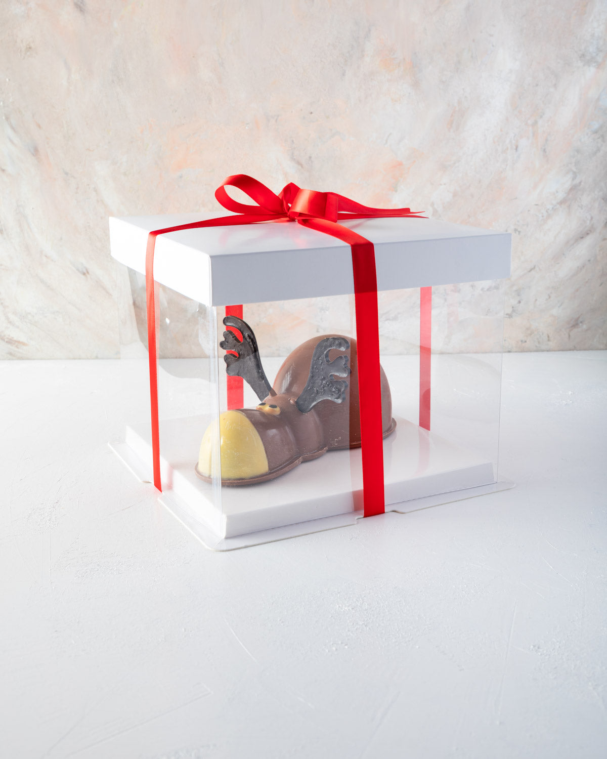 Rudolph the Chocolate DeerChocolate & ConfectioneryYOUR GIFT CONTAINS Rudolph, the edible Reindeer. A happy and funny Reindeer for Christmas made with approx 550gms of pure milk and white chocolate Chocolate Dimensions: LXBXH: 19.5x10x10cm Flavors: Pure B