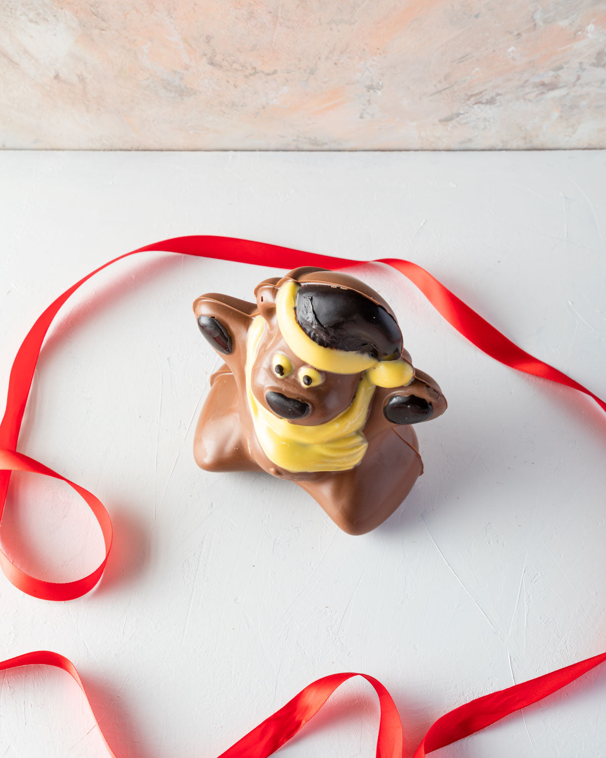 Chocolate Bear by NJDChocolate & ConfectioneryYOUR GIFT CONTAINS A happy and fun Christmas teddy made with approx 450gms of milk, white and dark chocolate Chocolate Dimensions: LxBxH: 12x12.5x15cm Flavors: Pure Belgian Milk chocolate and Color chocolate B