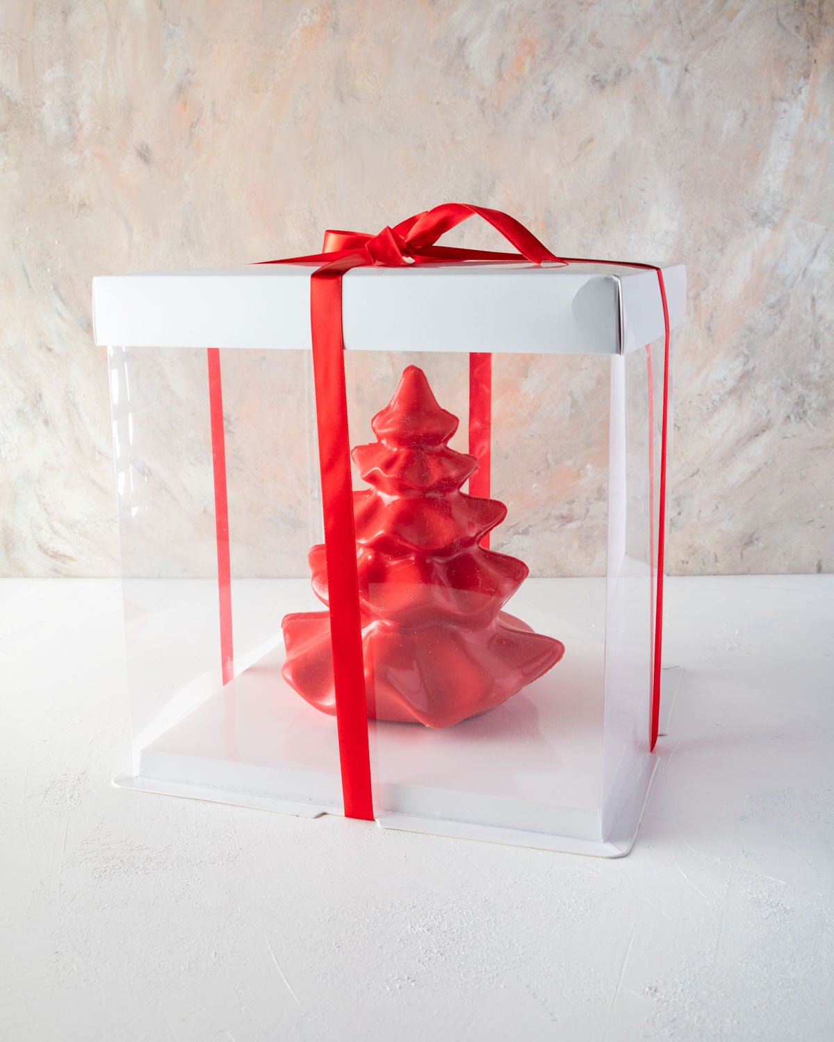 Tutu Edible Xmas Tree by NJDChocolate & ConfectioneryYOUR GIFT CONTAINS An elegant and shining Christmas Tree made with milk and colored chocolate weighing approx 750gms Chocolate Dimensions: LxBxH: 17x17x20cm Flavors: Pure Belgian Milk chocolate and Colo