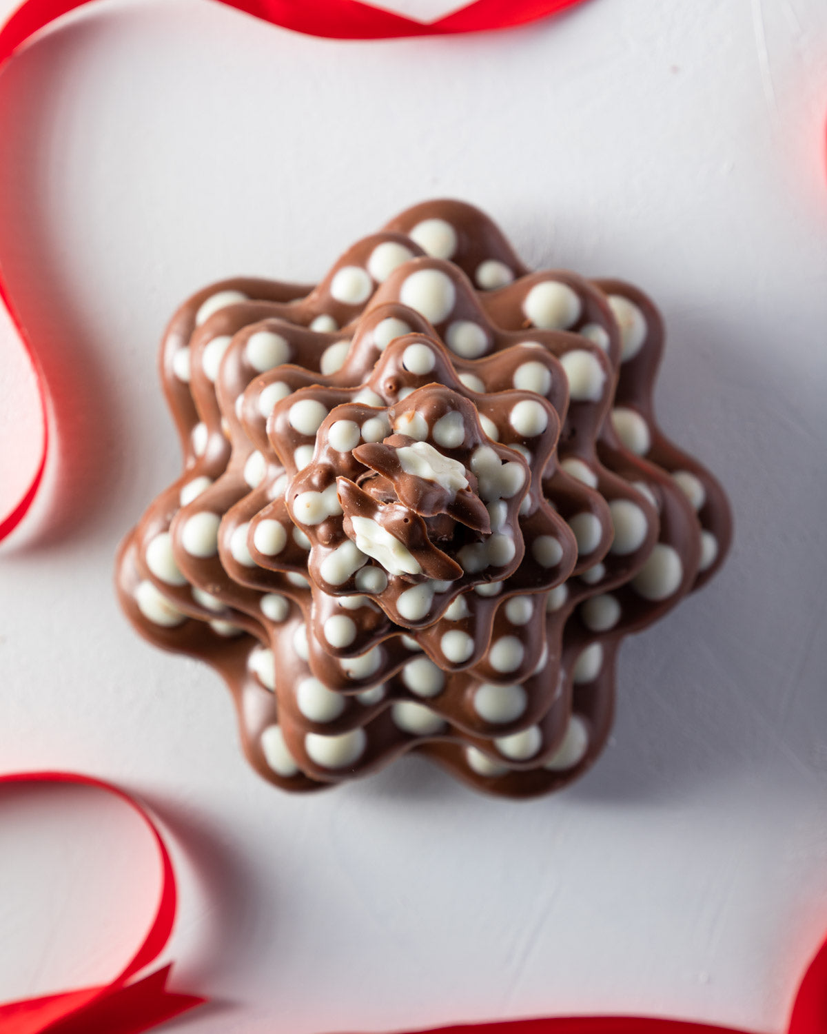 Christmas Kringle TreeChocolate & ConfectioneryYOUR GIFT CONTAINS Lots of levels to be decorated using your imagination for a modern 20cm tall Xmas tree weighing approx 850gms Chocolate Dimensions: LxBxH: 16x16x20cm Flavors: Pure Belgian Milk chocolate an