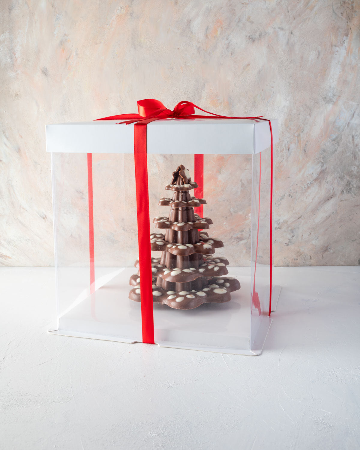 Christmas Kringle TreeChocolate & ConfectioneryYOUR GIFT CONTAINS Lots of levels to be decorated using your imagination for a modern 20cm tall Xmas tree weighing approx 850gms Chocolate Dimensions: LxBxH: 16x16x20cm Flavors: Pure Belgian Milk chocolate an