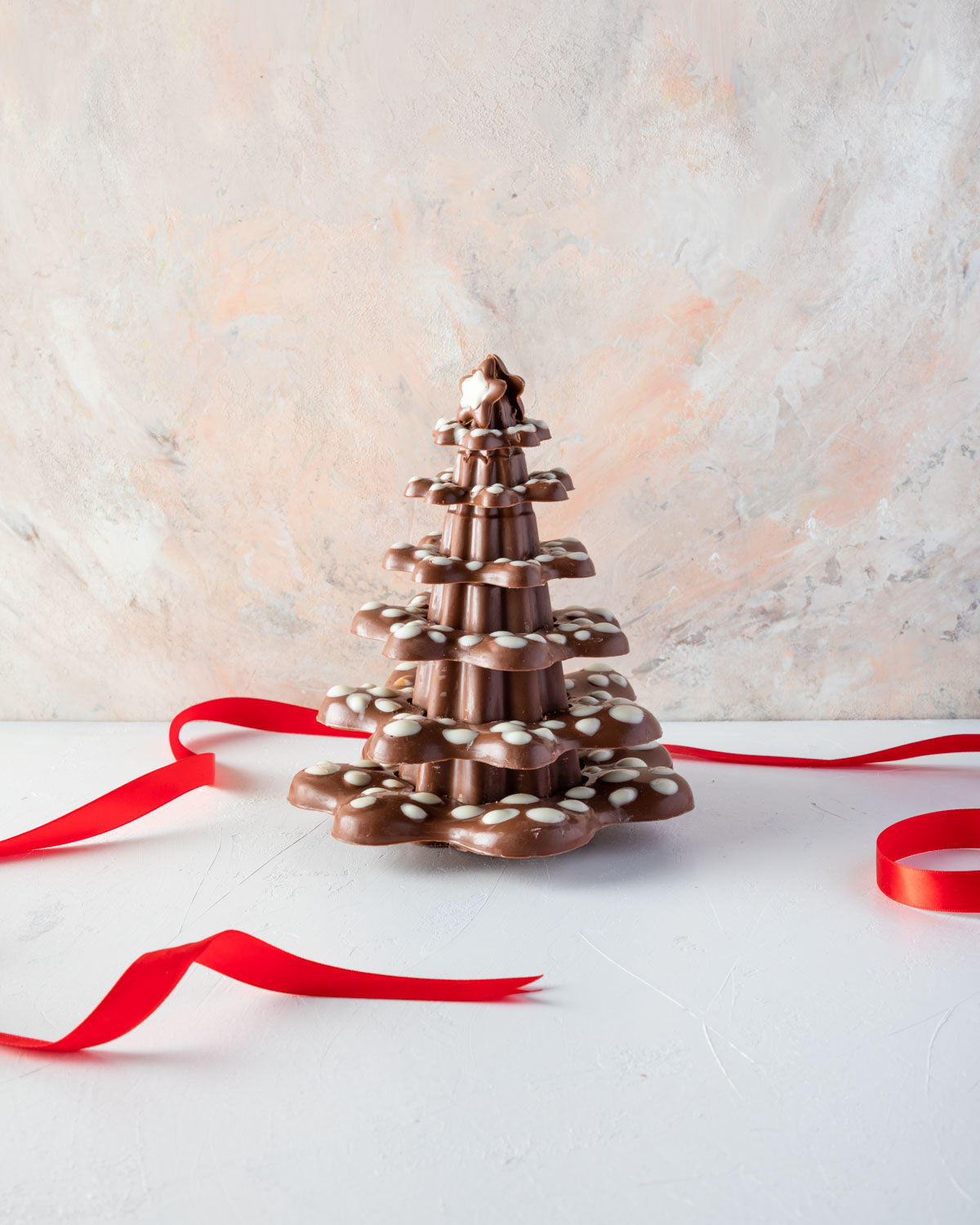 Christmas Kringle TreeChocolate & ConfectioneryYOUR GIFT CONTAINS Lots of levels to be decorated using your imagination for a modern 20cm tall Xmas tree weighing approx 850gms Chocolate Dimensions: LxBxH: 16x16x20cm Flavors: Pure Belgian Milk chocolate an