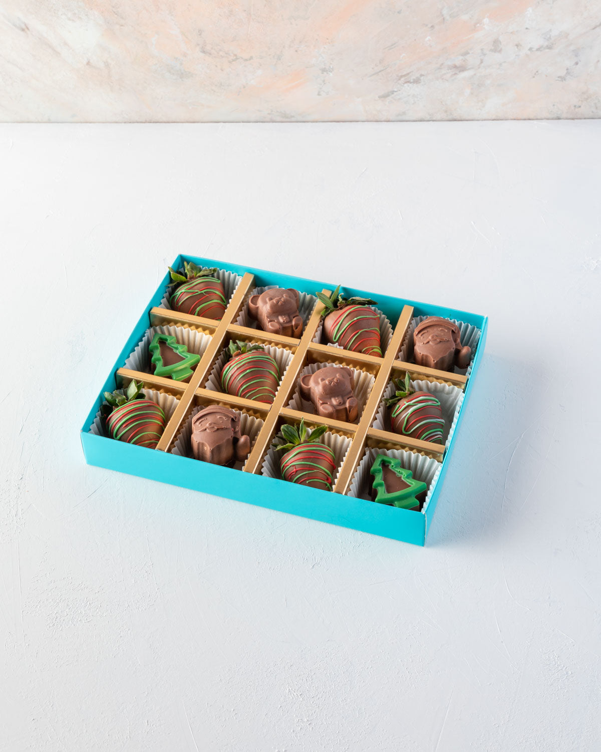 Assorted Santa and Strawberry Box by NJDChocolate & ConfectioneryYOUR GIFT CONTAINS 6pcs Milk chocolate strawberries designed in Xmas theme 6pcs assorted chocolates as Santa and Teddy bear Flavors: Chocolates flavours: praline and nuts Box dimensions: LxB