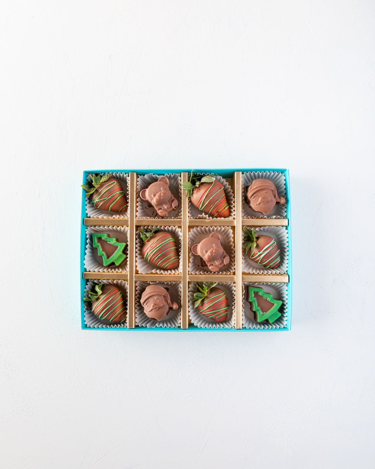 Assorted Santa and Strawberry Box by NJDChocolate & ConfectioneryYOUR GIFT CONTAINS 6pcs Milk chocolate strawberries designed in Xmas theme 6pcs assorted chocolates as Santa and Teddy bear Flavors: Chocolates flavours: praline and nuts Box dimensions: LxB