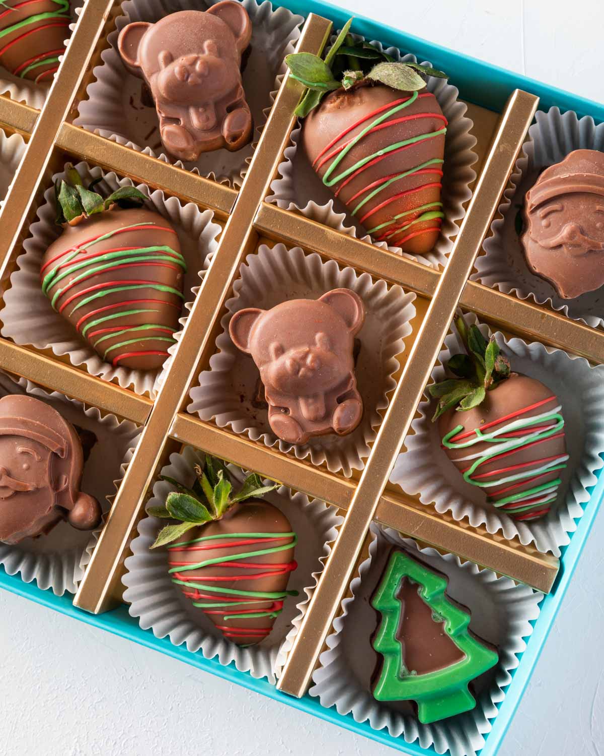 Assorted Santa and Strawberry Box by NJDChocolate & ConfectioneryYOUR GIFT CONTAINS 6pcs Milk chocolate strawberries designed in Xmas theme 6pcs assorted chocolates as Santa and Teddy bear Flavors: Chocolates flavours: praline and nuts Box dimensions: LxB
