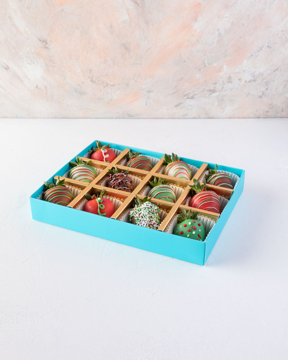 12pcs Christmas StrawberriesChocolate & ConfectioneryYOUR GIFT CONTAINS 12pcs chocolate covered strawberries designed in Xmas theme Flavors: Milk and colored chocolate covered fresh strawberries Box dimensions: LxBxH: 24x18.5x3.5cm HANDLING AND STORAGE Ke