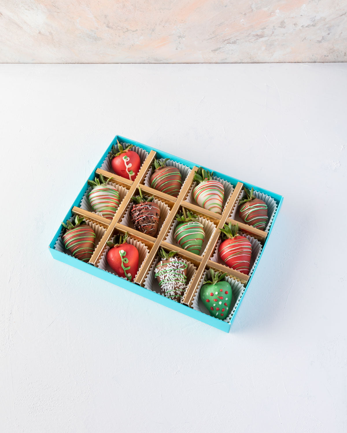 12pcs Christmas StrawberriesChocolate & ConfectioneryYOUR GIFT CONTAINS 12pcs chocolate covered strawberries designed in Xmas theme Flavors: Milk and colored chocolate covered fresh strawberries Box dimensions: LxBxH: 24x18.5x3.5cm HANDLING AND STORAGE Ke