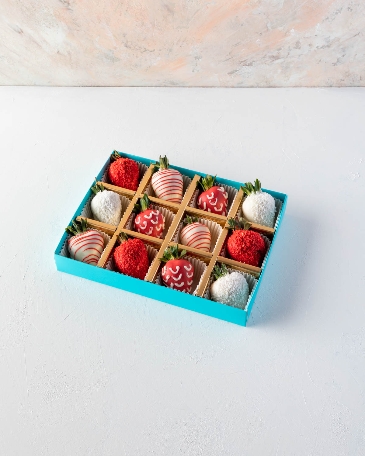 12pcs Red and White Strawberries by NJDChocolate & ConfectioneryYOUR GIFT CONTAINS 12pcs of strawberries covered in pure Belgian rich Milk chocolate sprinkled with edible glitters Flavors: White and colored chocolate, fresh strawberries Box dimensions: Lx