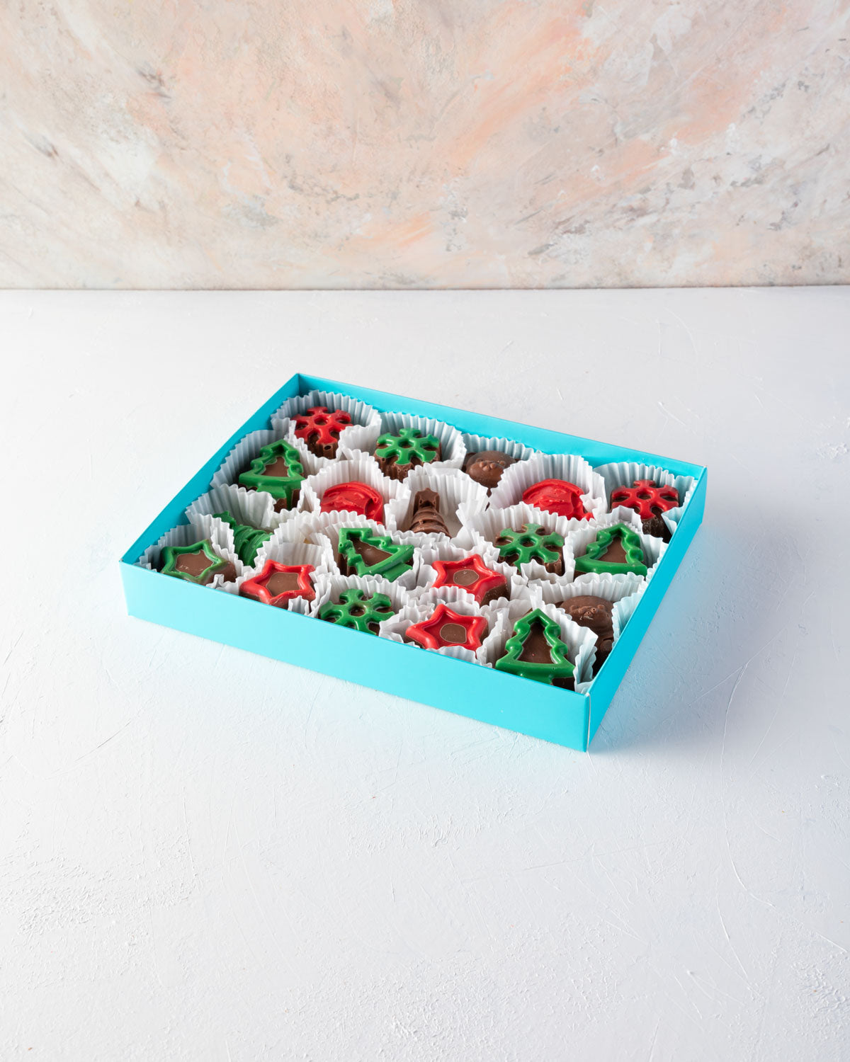 Xmas treat box by NJDChocolate & ConfectioneryYOUR GIFT CONTAINS 20pcs chunky assorted chocolates in Xmas theme shapes such as mini Christmas tree, Snowflakes, Father Christmas and Stars made with Milk and color chocolates - box weight approx 600gms Flavo