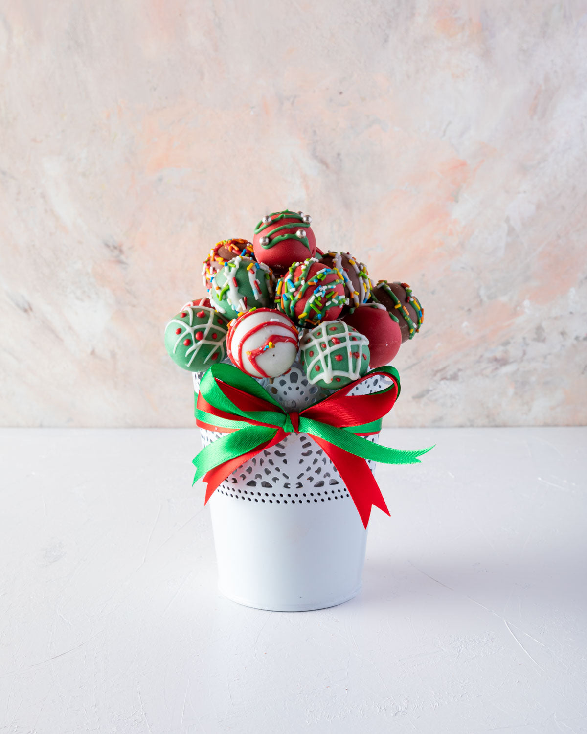 Colorful Truffles by NJDChocolate & ConfectioneryYOUR GIFT CONTAINS 15 pieces of delectable assorted truffles hand designed and sprinkled with Christmas colors Flavors: Assorted flavours such as praline, ganache, lotus, biscoff and roasted nuts Tub dimens