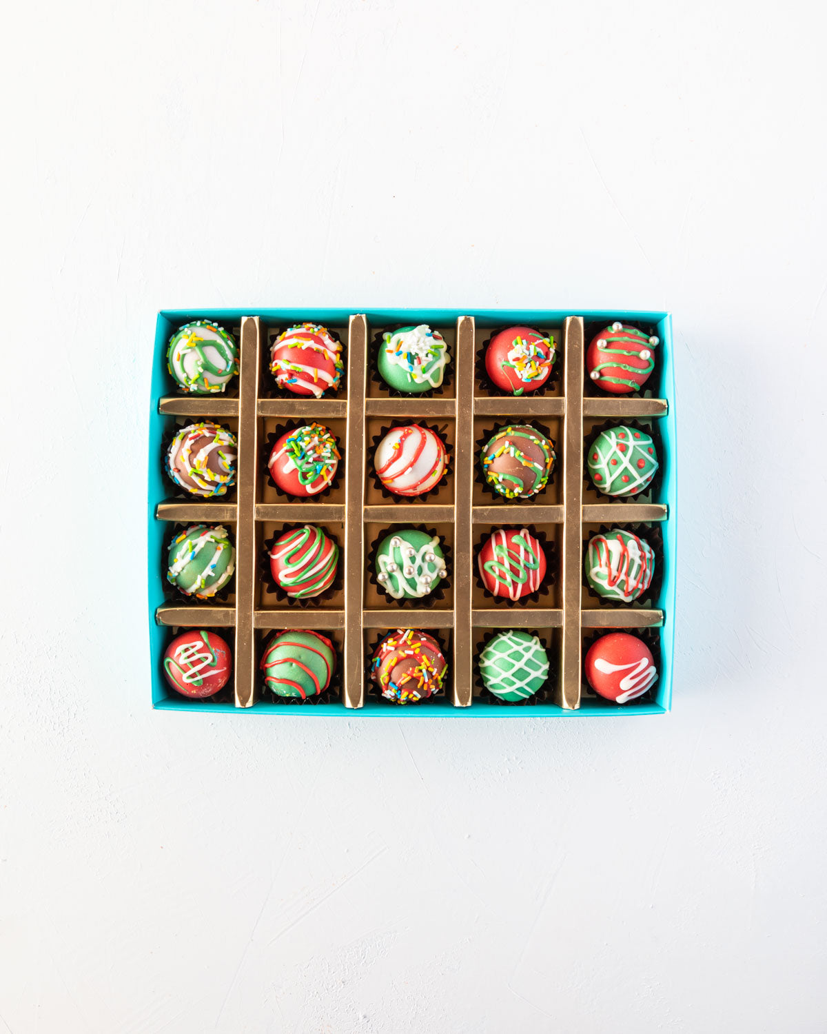 20pcs Christmas Truffles by NJDChocolate & ConfectioneryYOUR GIFT CONTAINS 20 pieces of delectable assorted truffles hand designed and sprinkled with Christmas colors Flavors: Assorted flavours such as praline, ganache, lotus, biscoff and roasted nuts Box