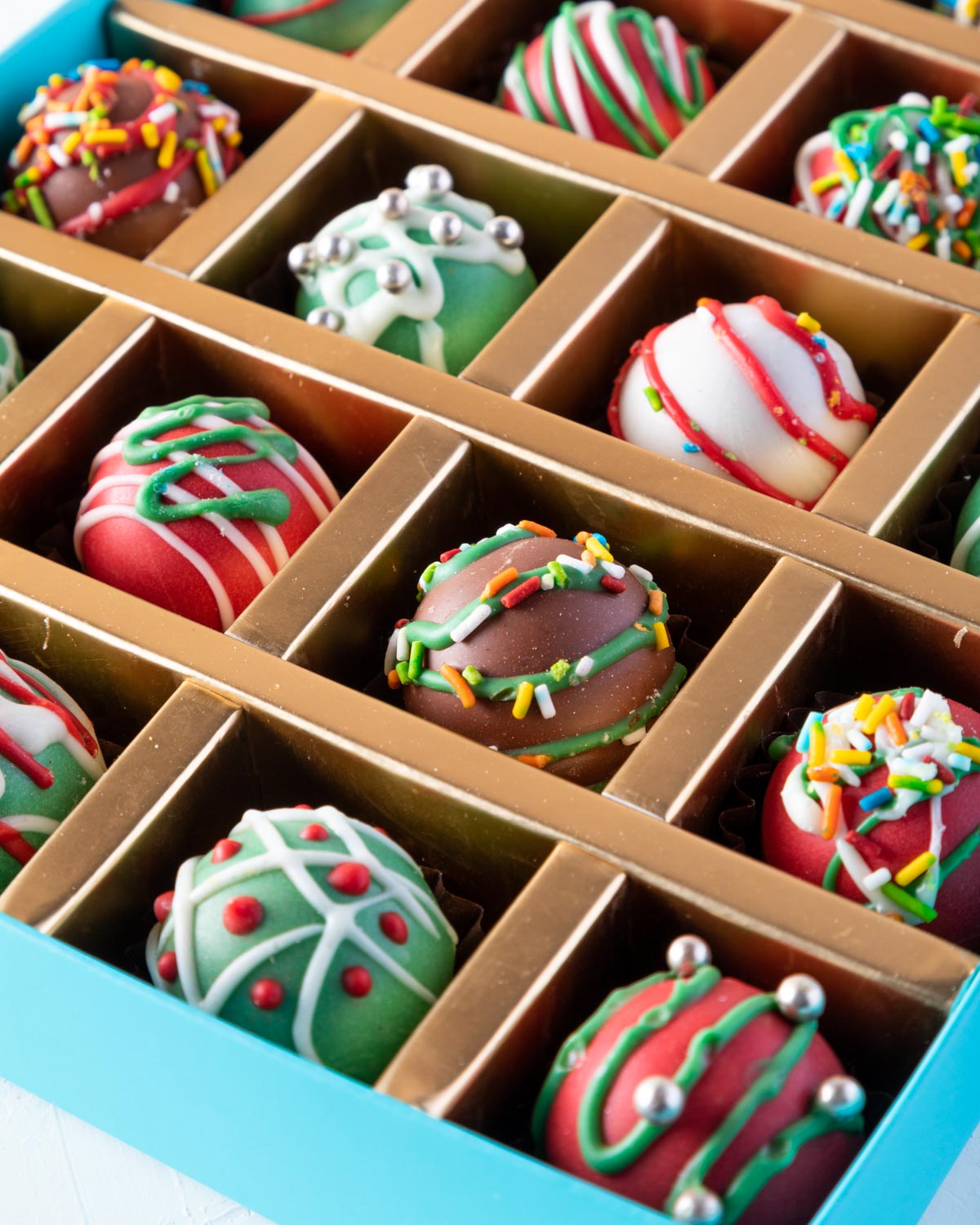 20pcs Christmas Truffles by NJDChocolate & ConfectioneryYOUR GIFT CONTAINS 20 pieces of delectable assorted truffles hand designed and sprinkled with Christmas colors Flavors: Assorted flavours such as praline, ganache, lotus, biscoff and roasted nuts Box