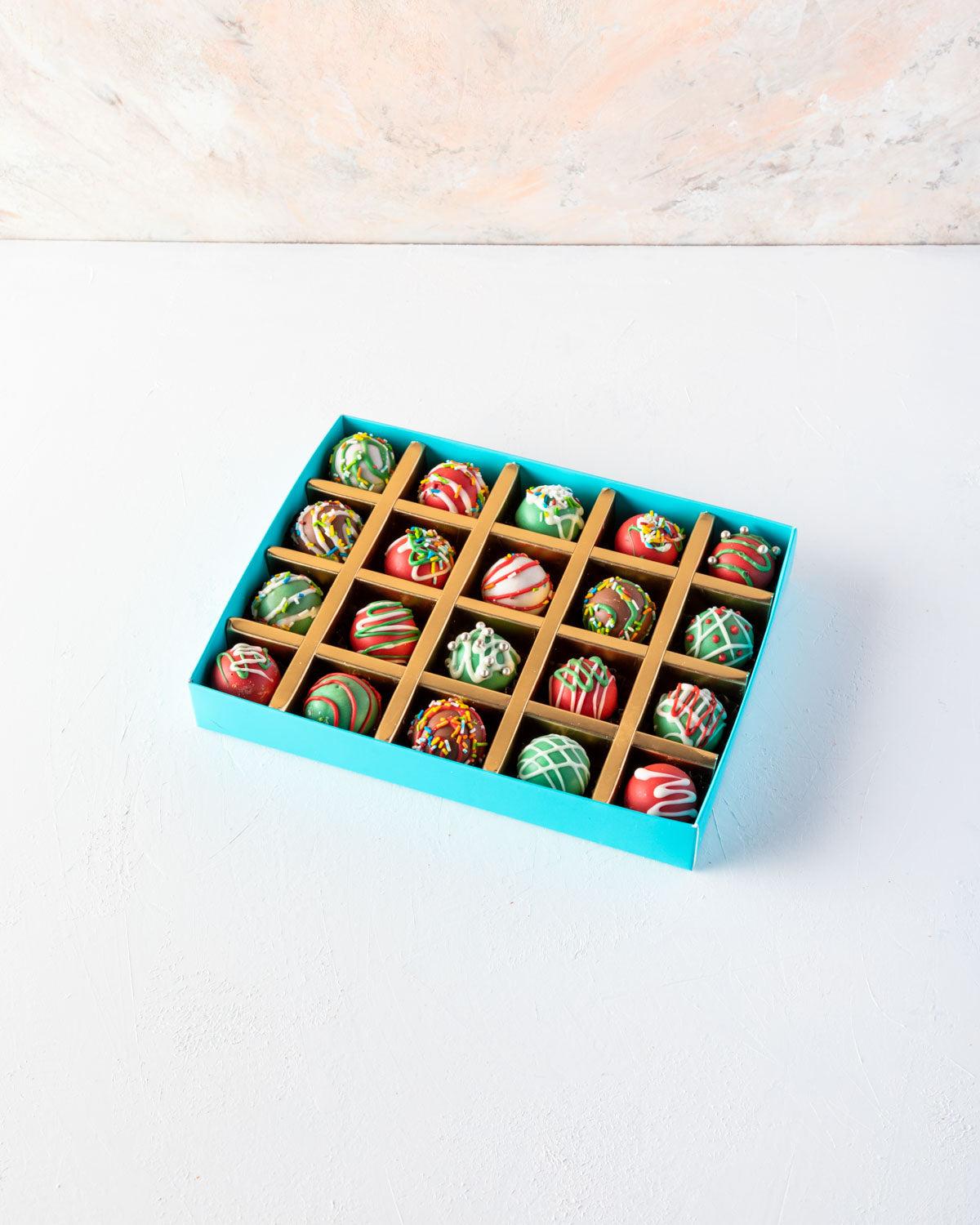 20pcs Christmas Truffles by NJDChocolate & ConfectioneryYOUR GIFT CONTAINS 20 pieces of delectable assorted truffles hand designed and sprinkled with Christmas colors Flavors: Assorted flavours such as praline, ganache, lotus, biscoff and roasted nuts Box