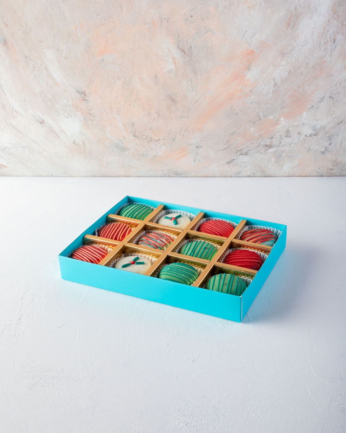 Holiday Chocolaty OreosChocolate & ConfectioneryYOUR GIFT CONTAINS Chocolate Oreos sandwitch - 12pcs oreos coated with milk, white and colored chocolate and hand designed in Christmas theme Flavors: Oreos and Chocolate Box dimensions: LxBxH: 24x18.5x3.5cm