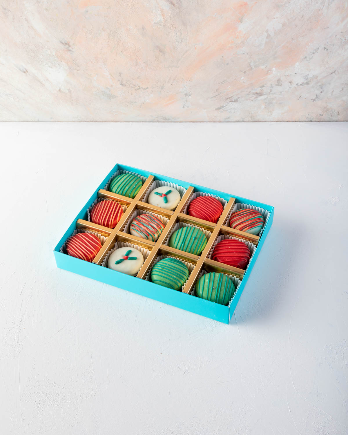 Holiday Chocolaty OreosChocolate & ConfectioneryYOUR GIFT CONTAINS Chocolate Oreos sandwitch - 12pcs oreos coated with milk, white and colored chocolate and hand designed in Christmas theme Flavors: Oreos and Chocolate Box dimensions: LxBxH: 24x18.5x3.5cm