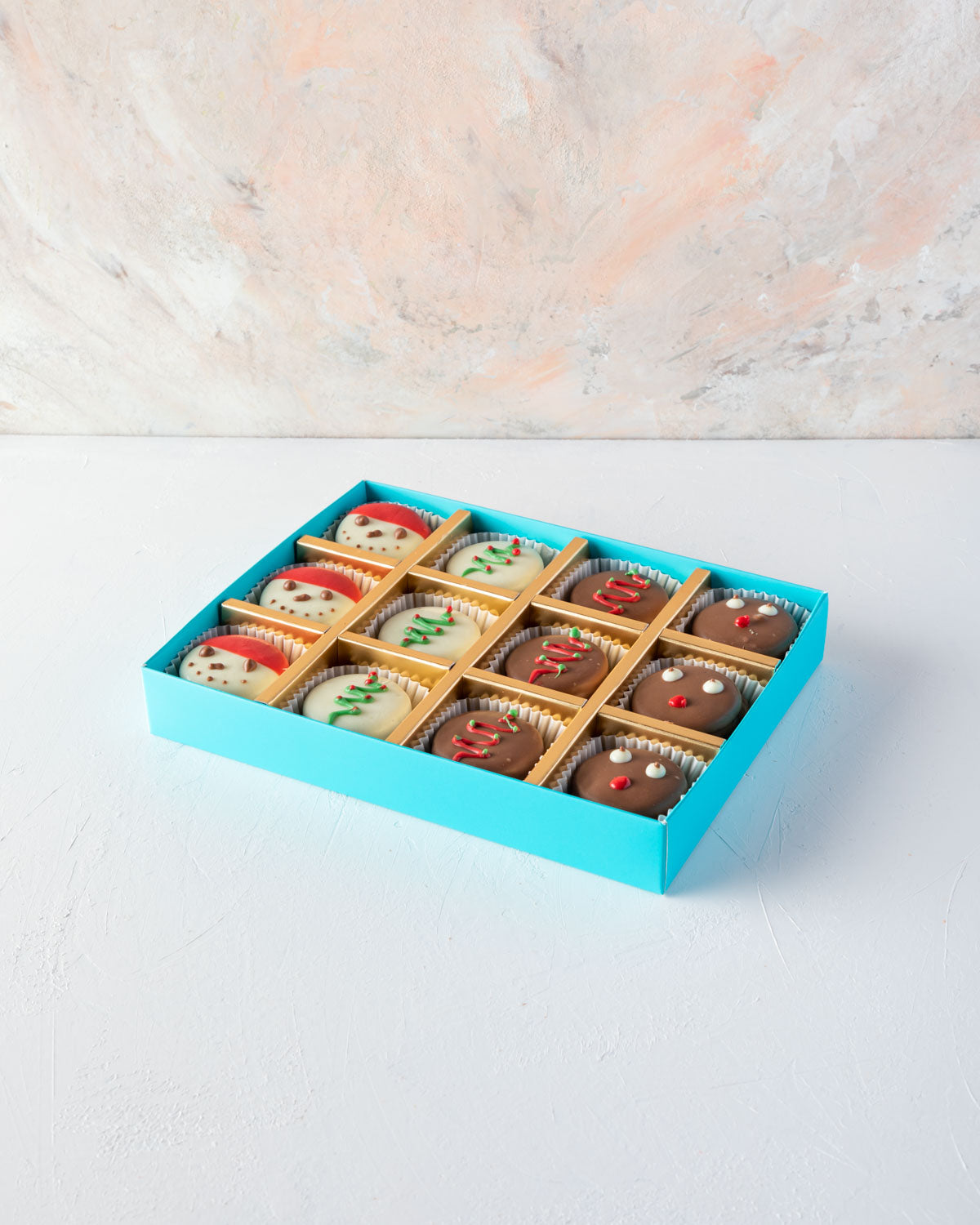 Chocolaty Xmassy Oreos by NJDChocolate & ConfectioneryYOUR GIFT CONTAINS 12pcs Chocolate covered oreo sandwitched hand designed in fun Christmas theme Flavors: Oreo cookies and pure Belgian chocolate Box dimensions: LxBxH: 24x18.5x3.5cm HANDLING AND STORA