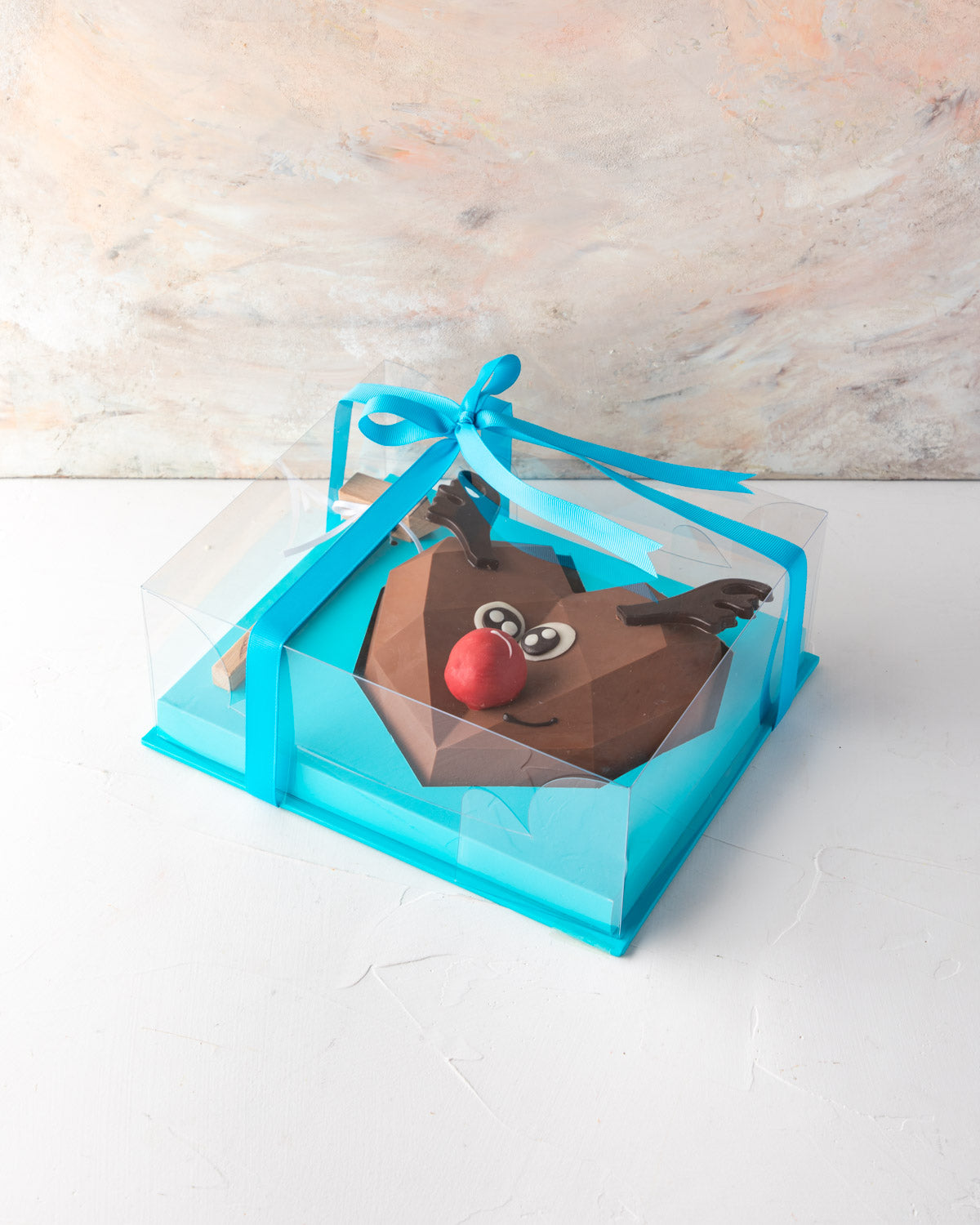 Piñata Reindeer by NJDChocolate & ConfectioneryYour Gift Contains: • Reindeer face Piñata made with approx. 400gms Milk Chocolate • 1 large Brownie cake pop as the nose • Filled with 10 pieces Christmas theme Milk chocolate Box Size: LxBxH: 21x25x9.5cm HA
