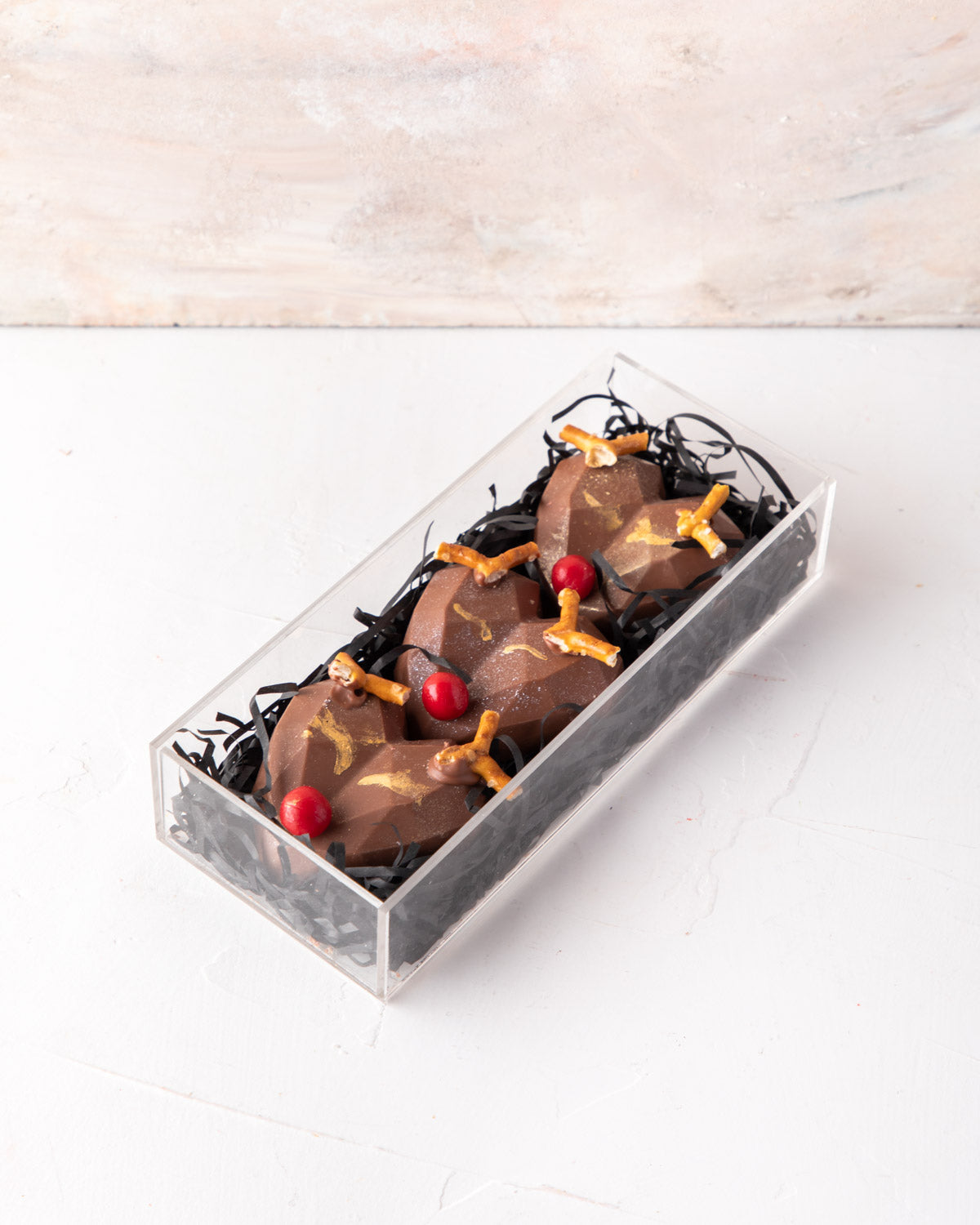 Assorted Reindeer by NJDChocolate & ConfectioneryYour Gift Contains: • 3 Pieces Milk chocolate designed as the Red nose Reindeer - Flavor: Rocher • Size of each piece - 5x6x2cm • Weight of each piece = 52gms / Total Weight of the chocolates: 156gms Box Si
