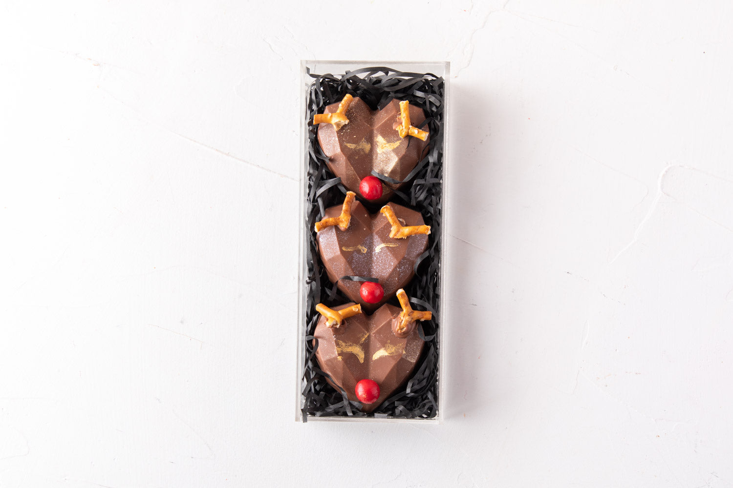 Assorted Reindeer by NJDChocolate & ConfectioneryYour Gift Contains: • 3 Pieces Milk chocolate designed as the Red nose Reindeer - Flavor: Rocher • Size of each piece - 5x6x2cm • Weight of each piece = 52gms / Total Weight of the chocolates: 156gms Box Si