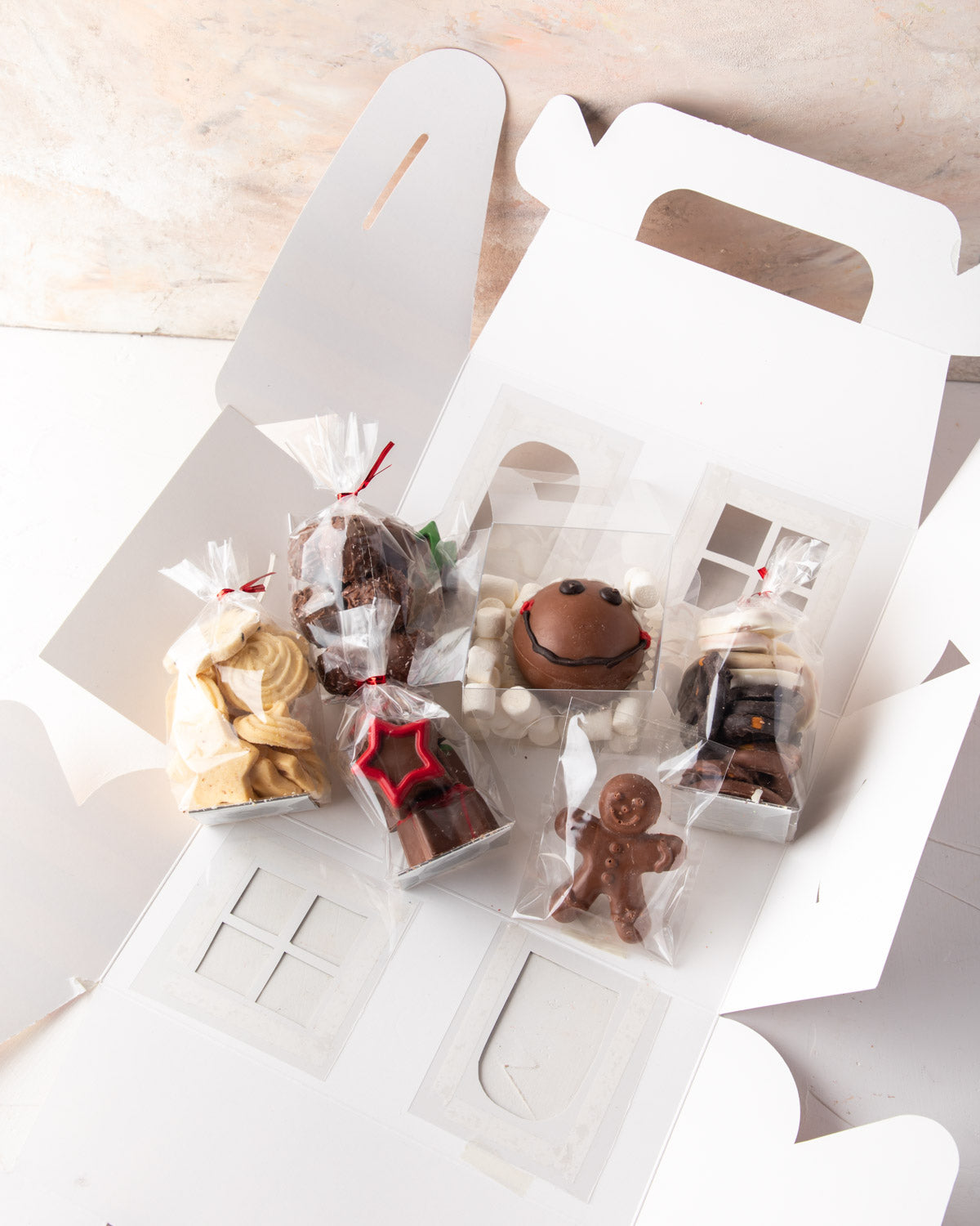 Christmas Treat box by NJDChocolate & ConfectioneryYour Gift Contains: • 1 pack freshly baked cookies • 1 hot chocolate bomb • 1 pack milk and dark chocolate covered Oreos • 1 pack milk chocolate ginger man • 1 pack chocolate brownie bites • 1 pack Christ