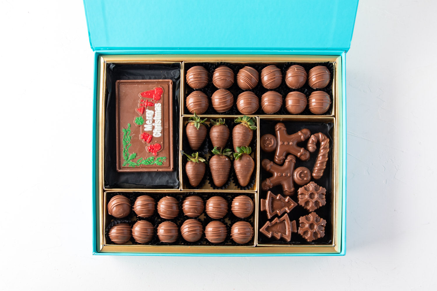 Assorted Christmas Greetings BoxChocolate & ConfectioneryYour Gift Contains: • 24 pieces Milk Chocolate Truffles in Peanut butter, Rice Crispy, Pistachio, Sepculoos and Hazelnut Gandoua and Pistachio Praline flavors • 50gms Milk Chocolate bar with Merry C